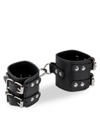 Black leather BDSM handcuffs with straps